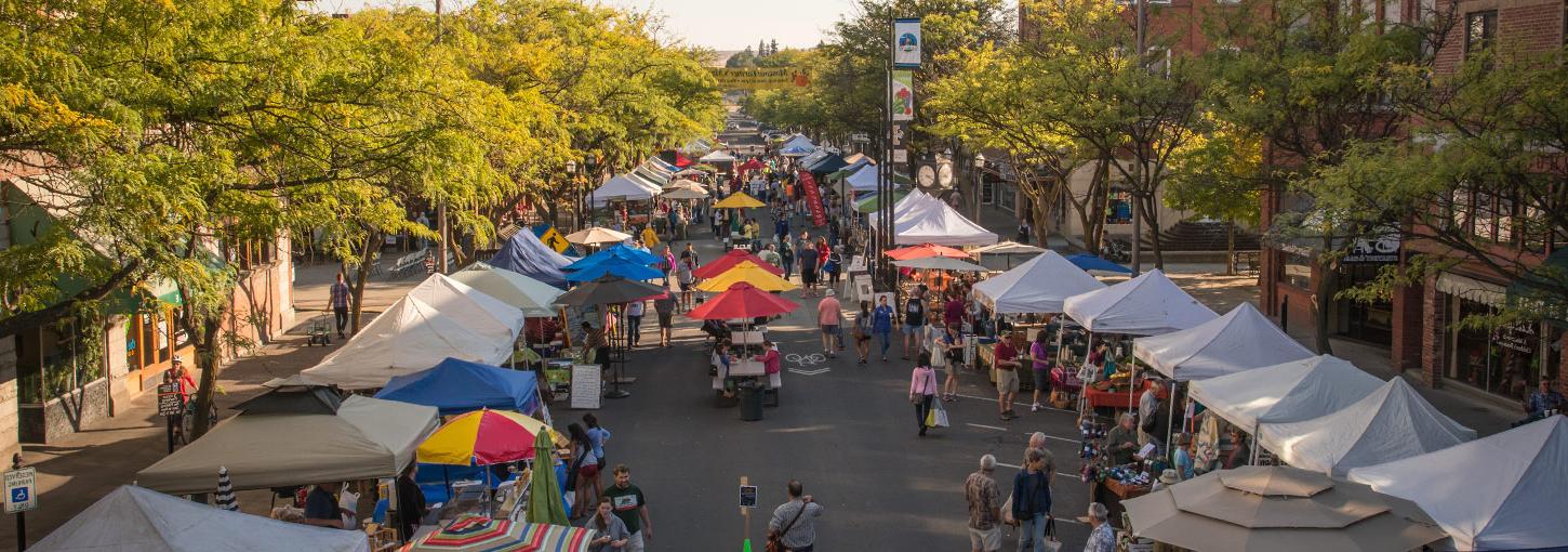 Merchants' booths and stalls line Main Street 莫斯科 on an early Saturday morning for the Farmers Market.