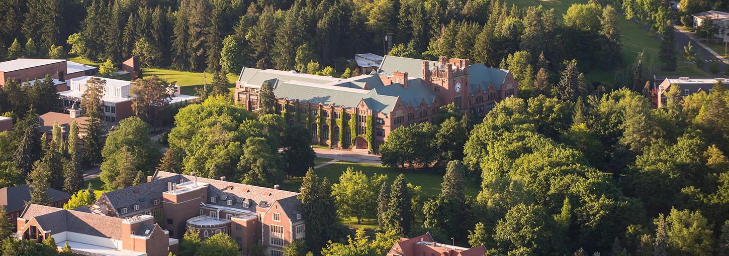 An aerial view of the U of I 莫斯科 campus, showcasing green trees and the Administration Building.